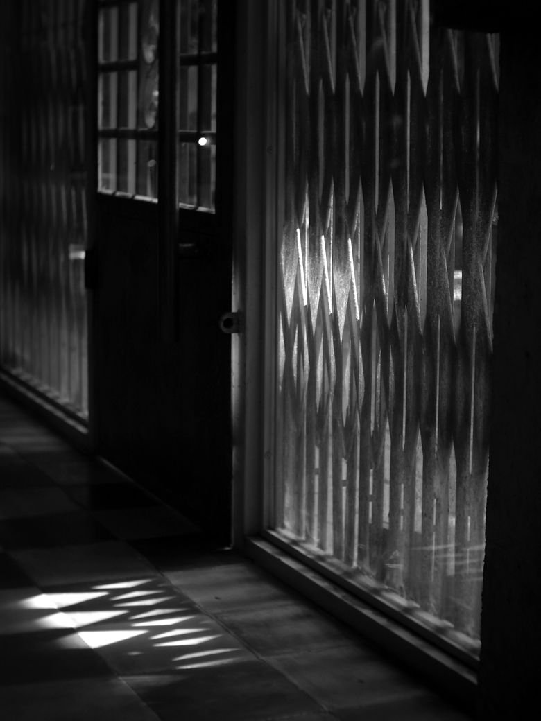 Light falling through patterned glass onto a tiled floor